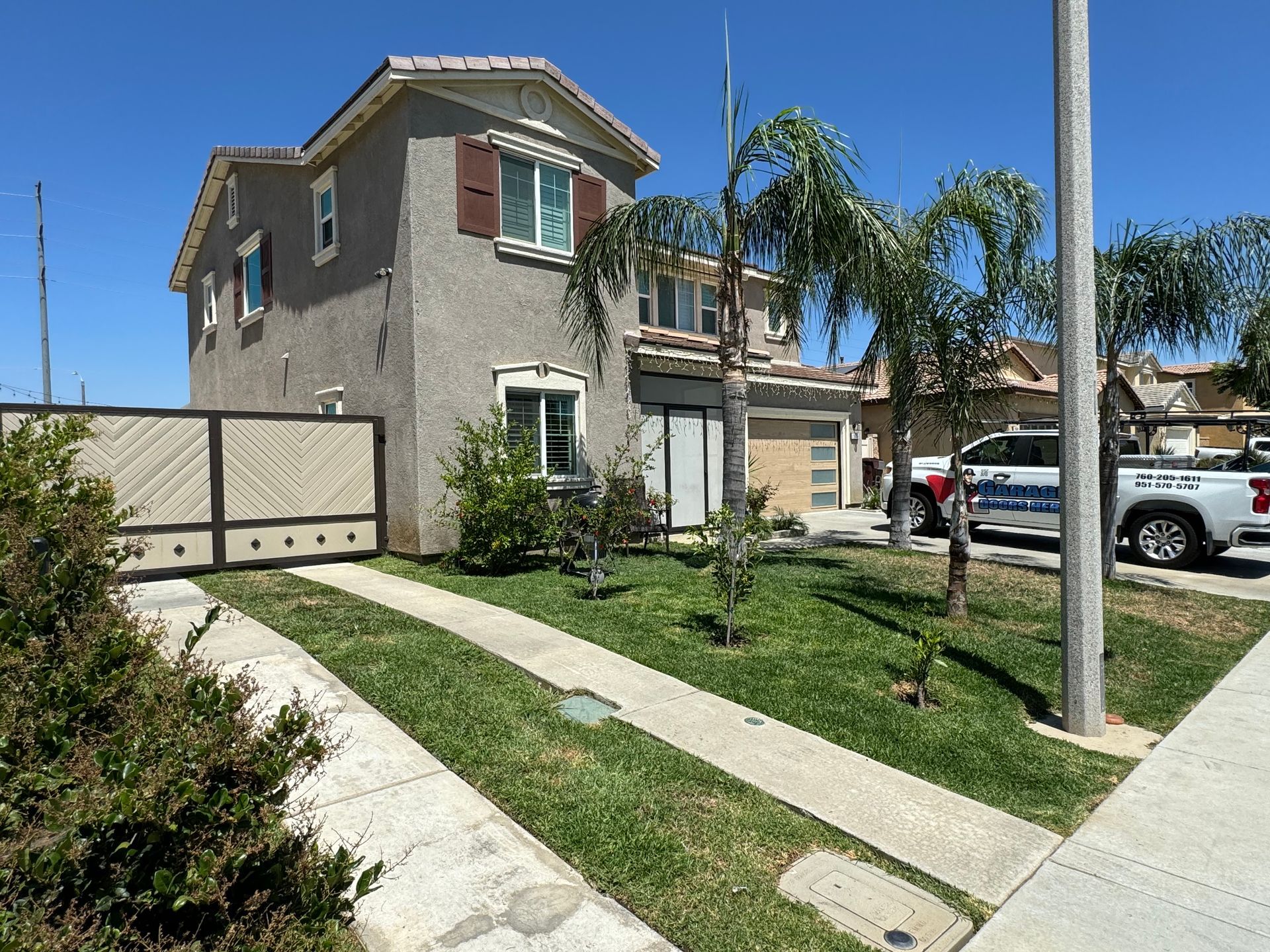 A house with a fence and a car parked in front of it