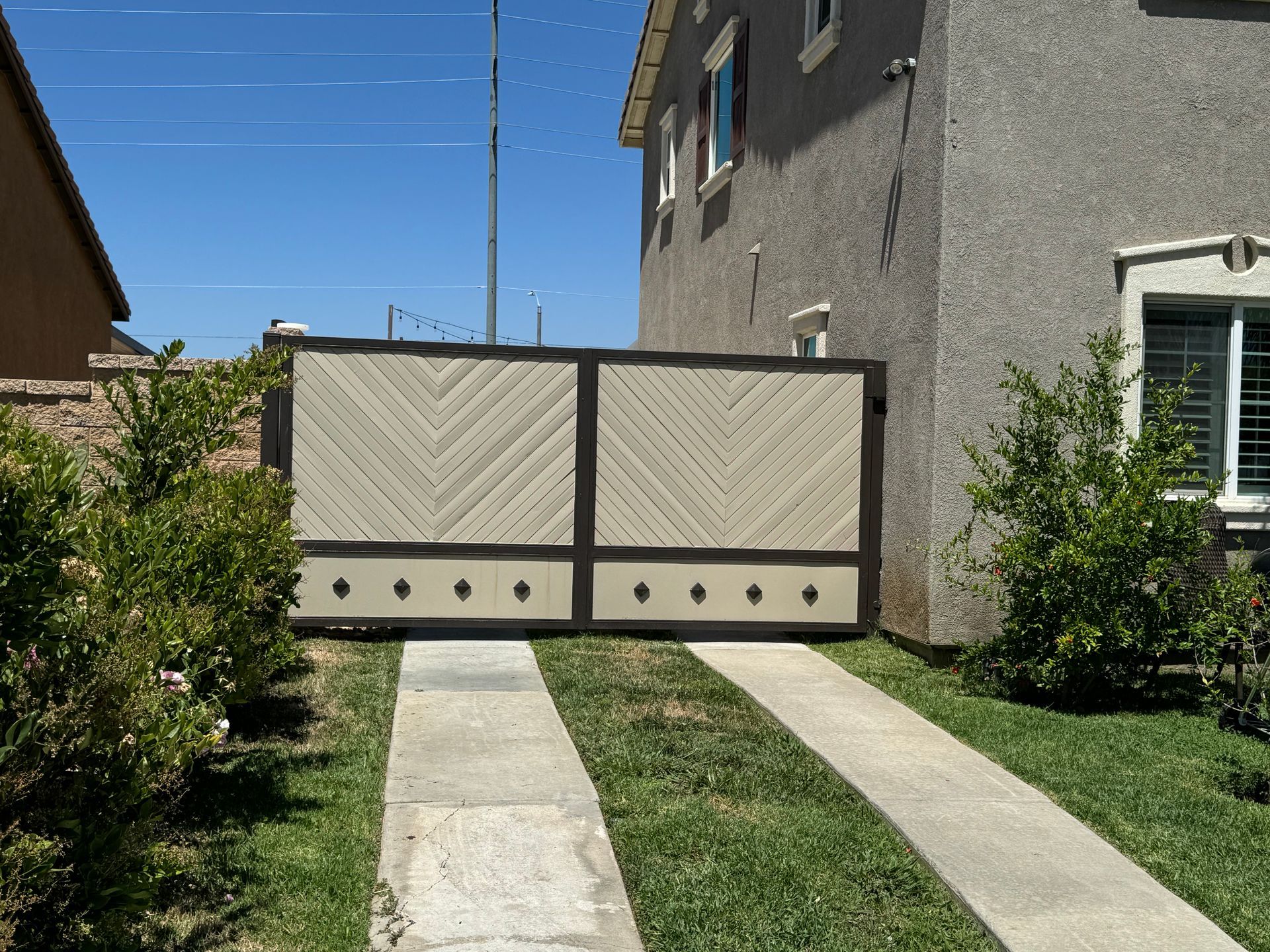 A house with a sliding gate in front of it
