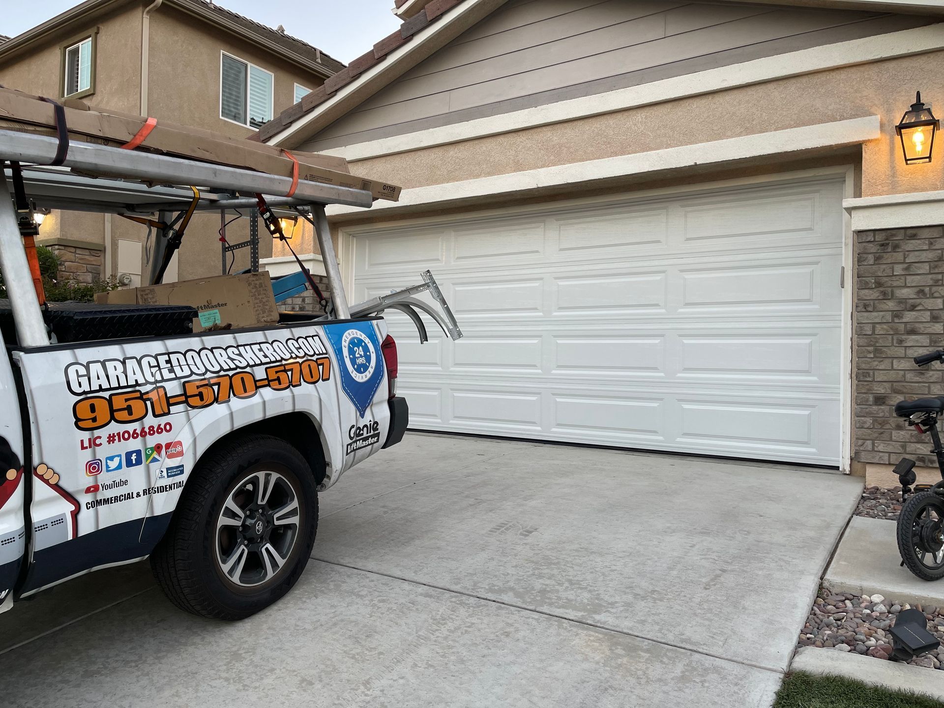 A truck is parked in front of a garage door.