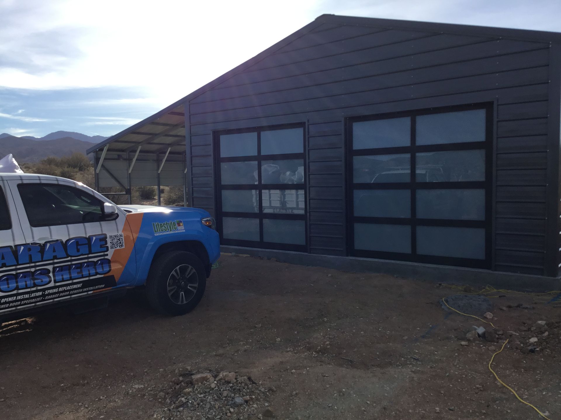 A garage door company truck is parked in front of a building