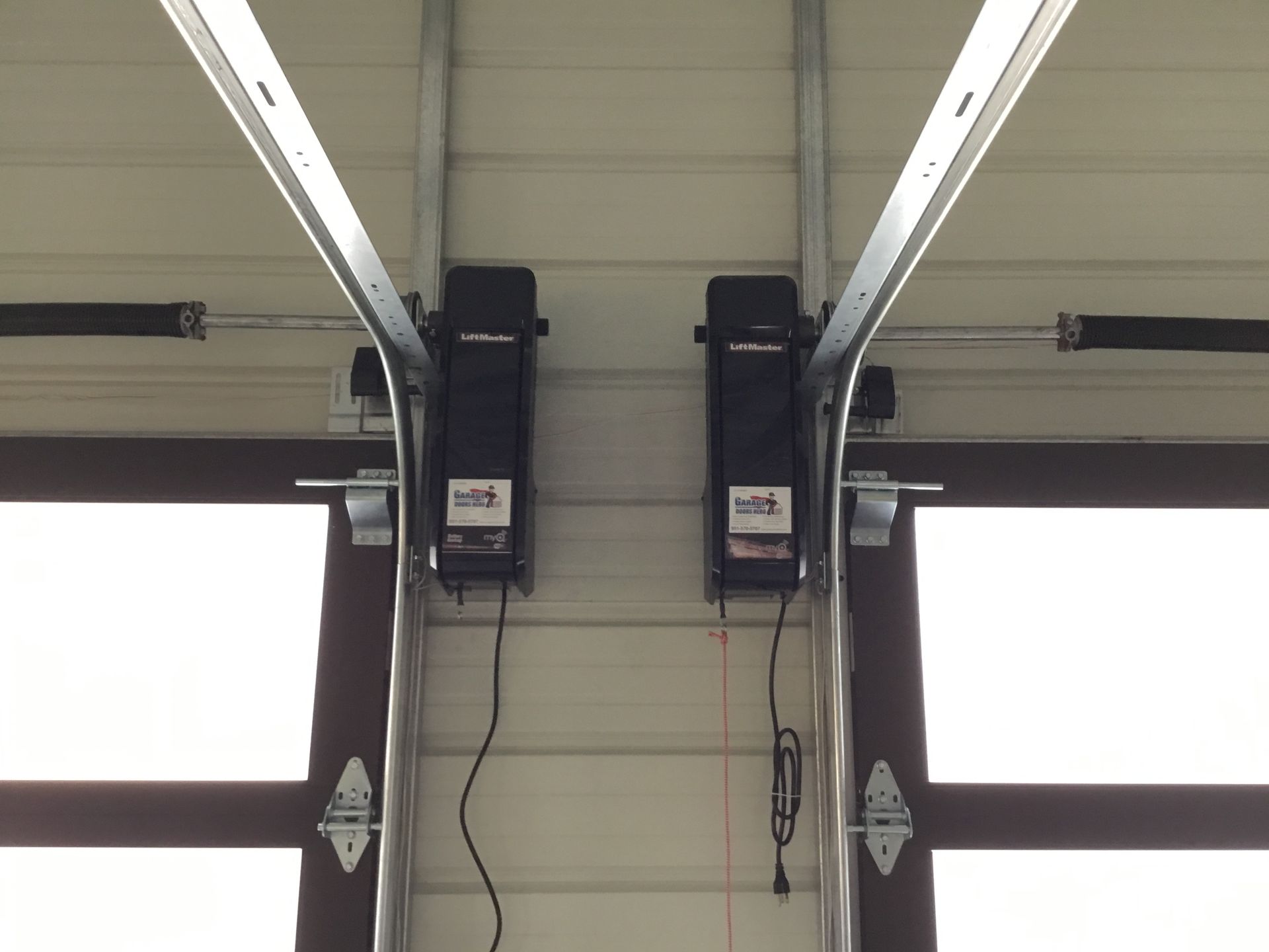A garage door opener is hanging from the ceiling