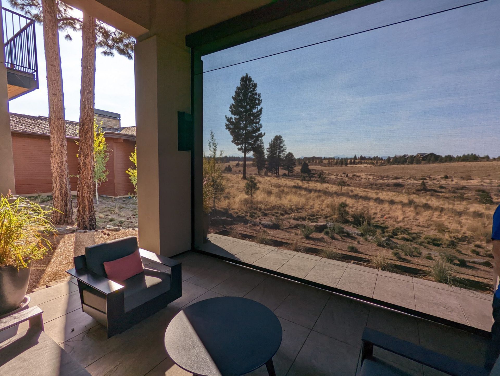 A red car and a black car are parked in a garage