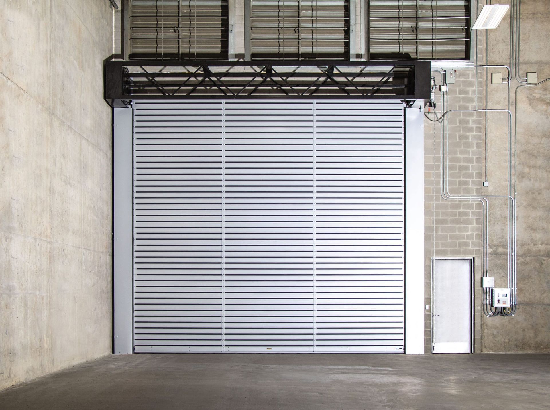 An empty warehouse with a large garage door