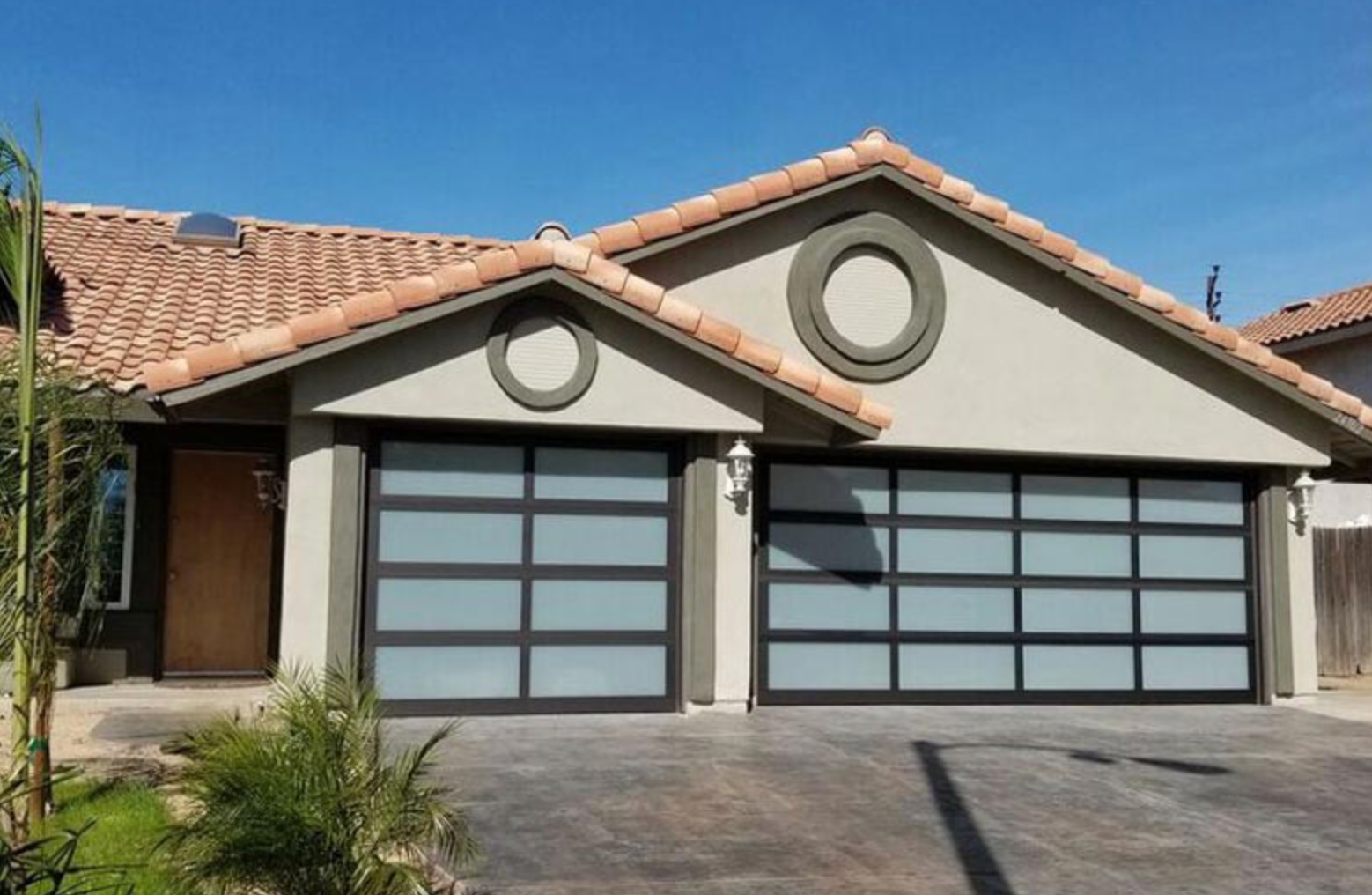 A house with two garage doors and a tiled roof