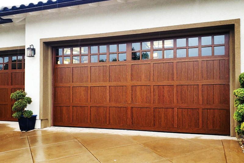 A large wooden garage door with a lot of windows