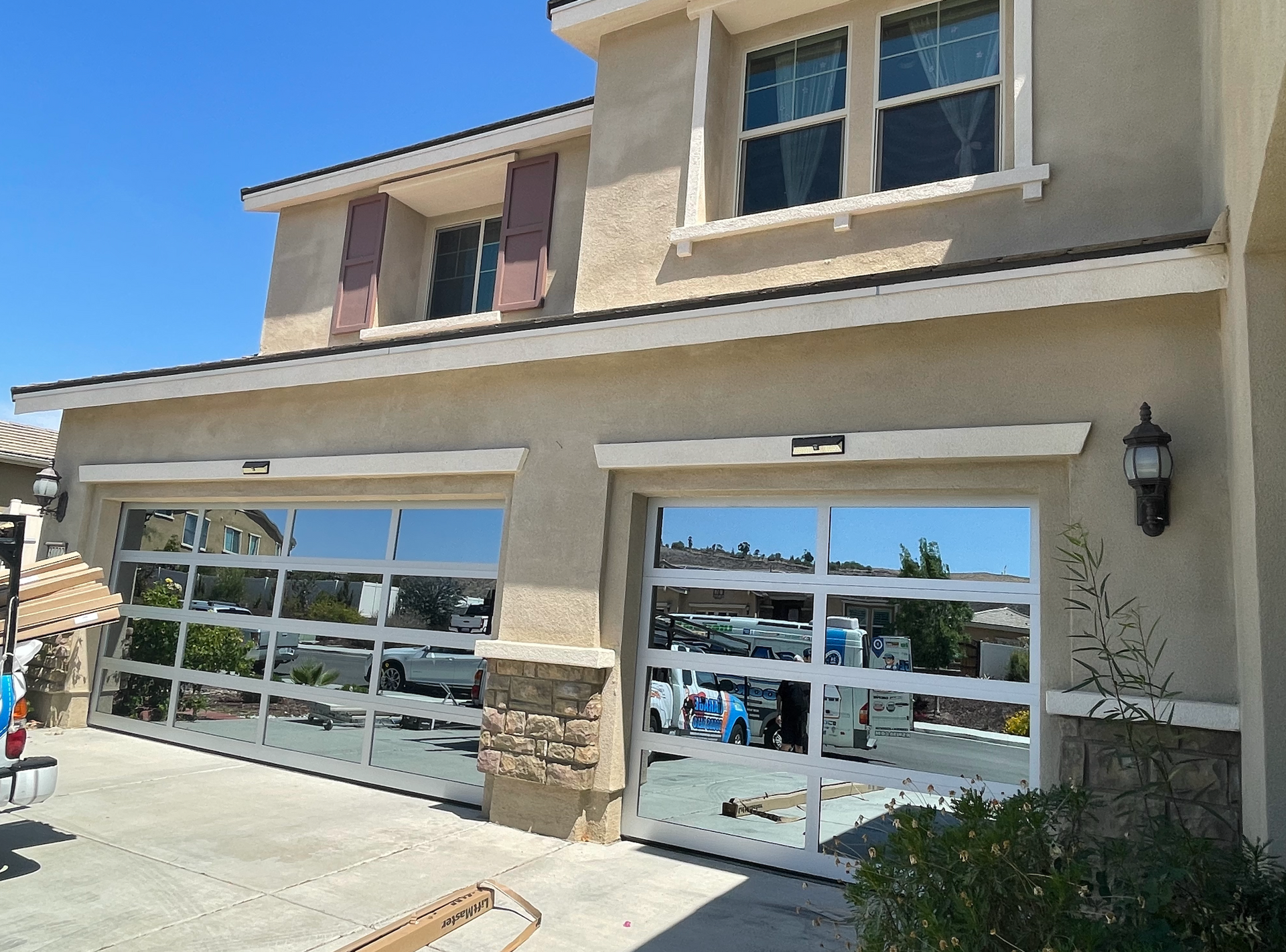 A house with a large garage door and a lot of windows