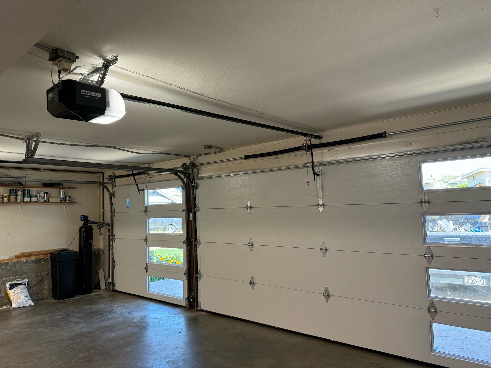 A garage with a garage door open and a garage door opener.