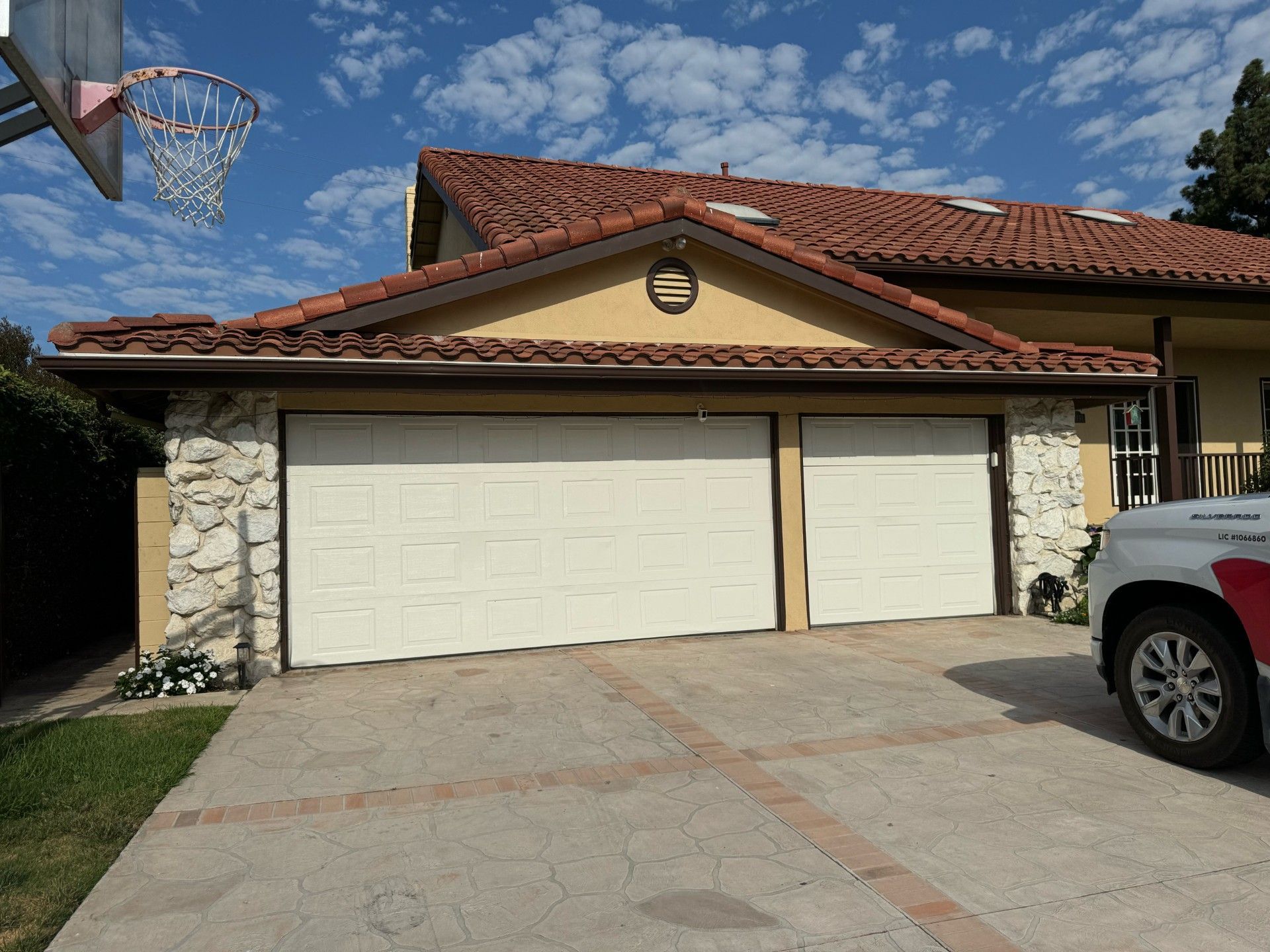 A truck is parked in front of a garage 