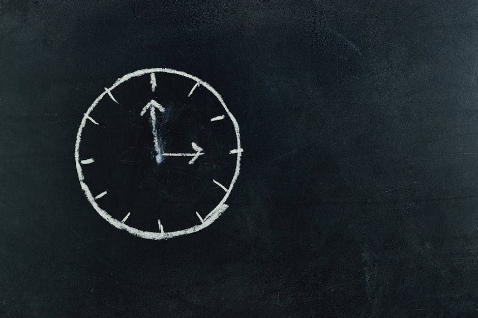 A chalk drawing of a clock on a blackboard