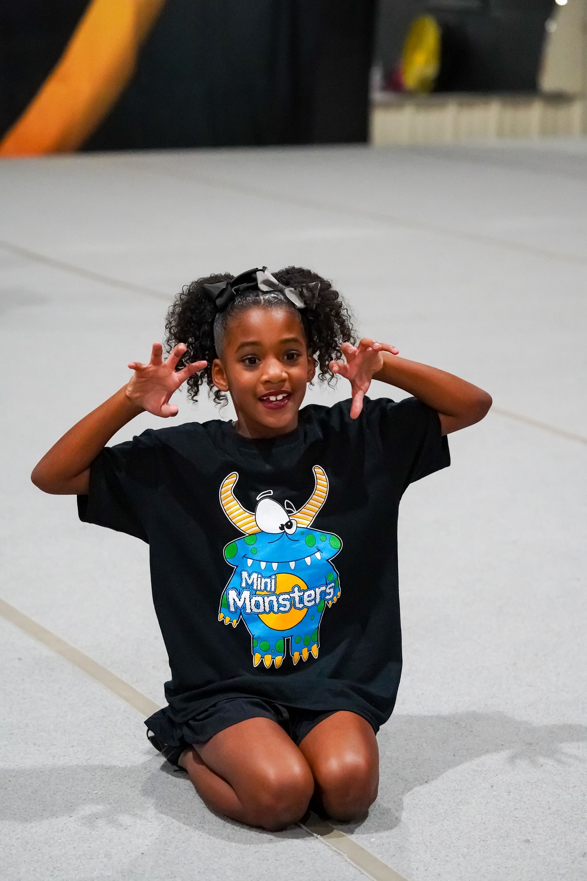 A girl with curly hair, wearing a 