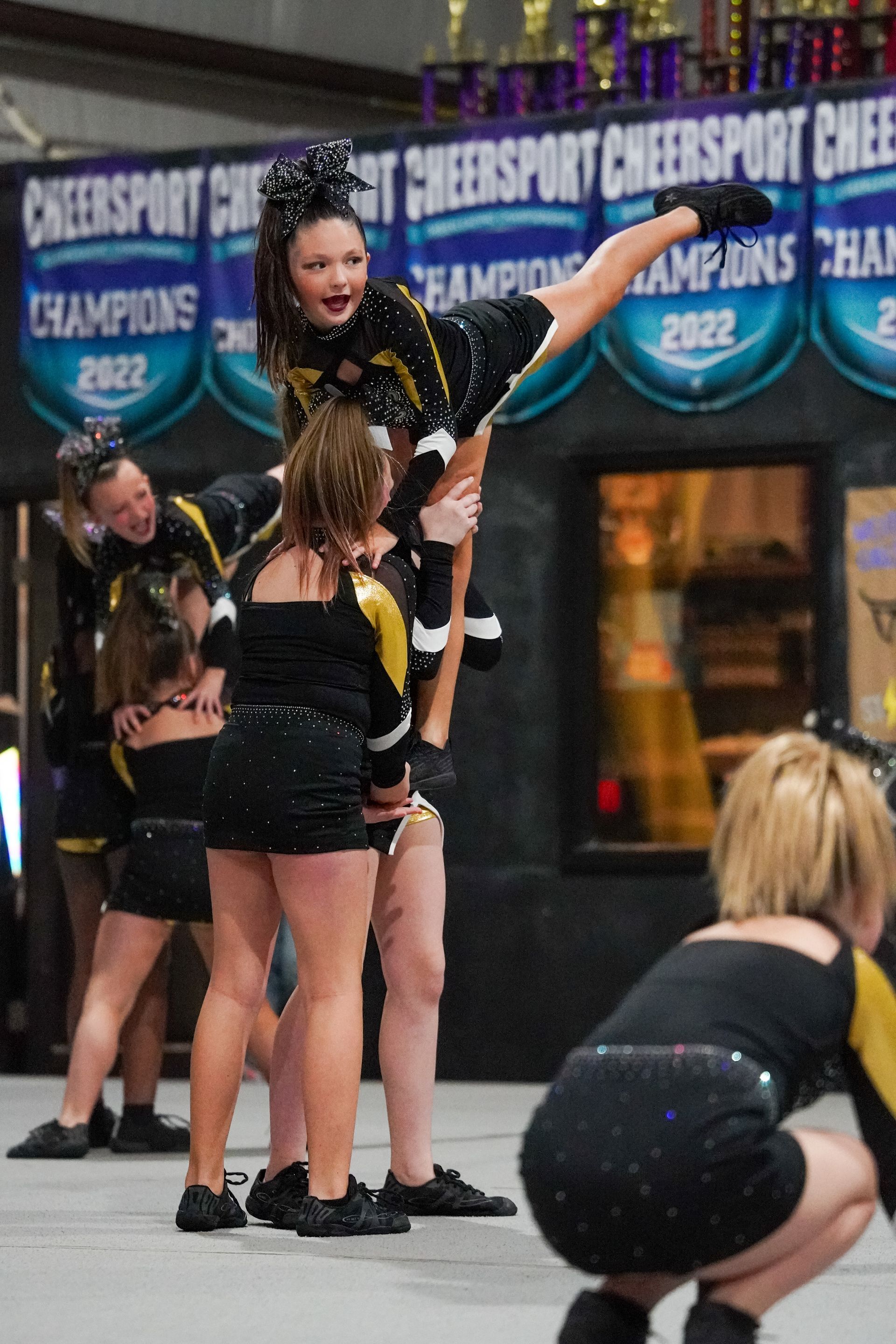 Cheerleaders performing a stunt at a competition. 