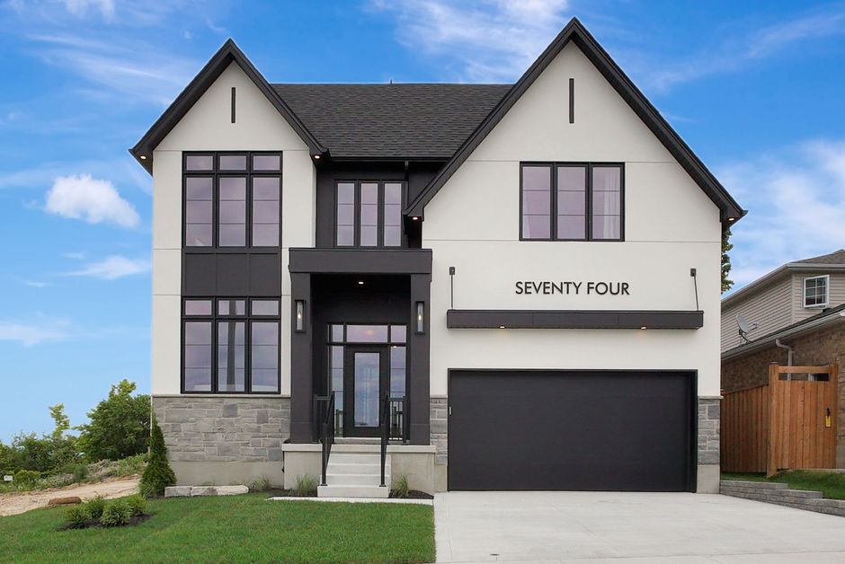 A car is parked in front of a house with the number 346 on it