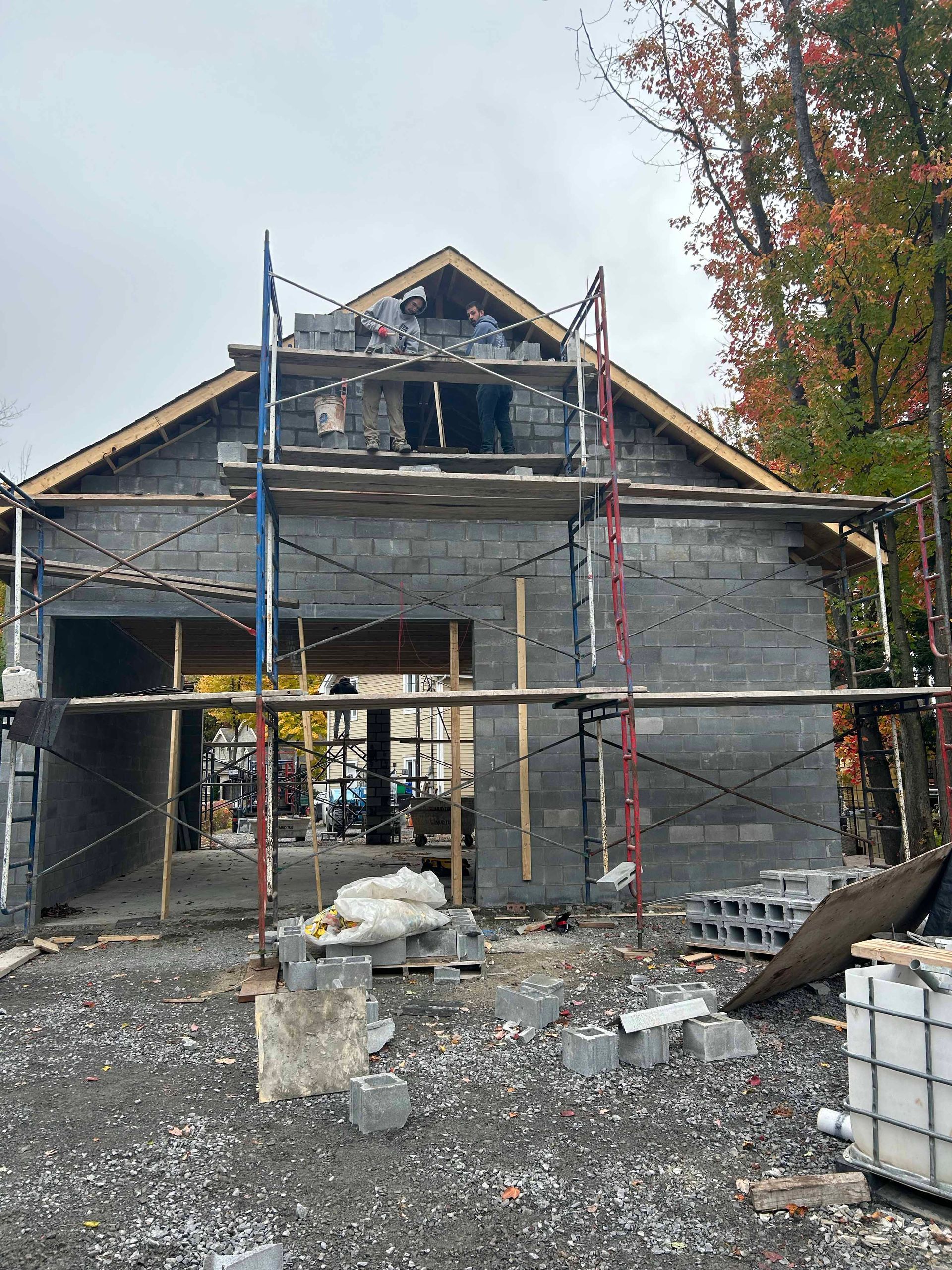 Une maison est en construction avec des échafaudages autour.