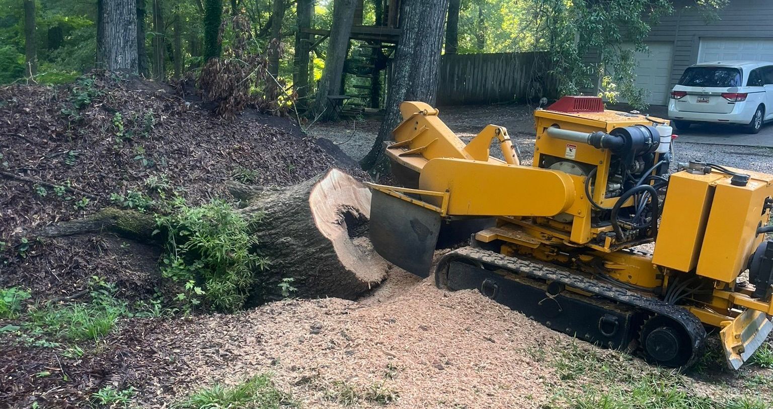 A close up of a stump grinder cutting a tree stump