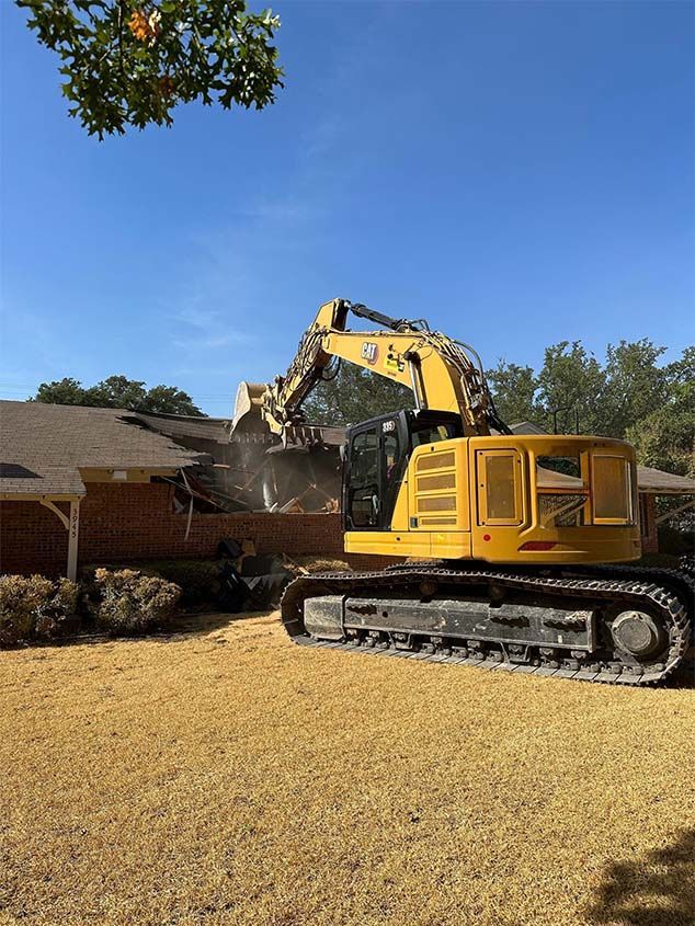 A bulldozer is moving a pile of rubble on a construction site.