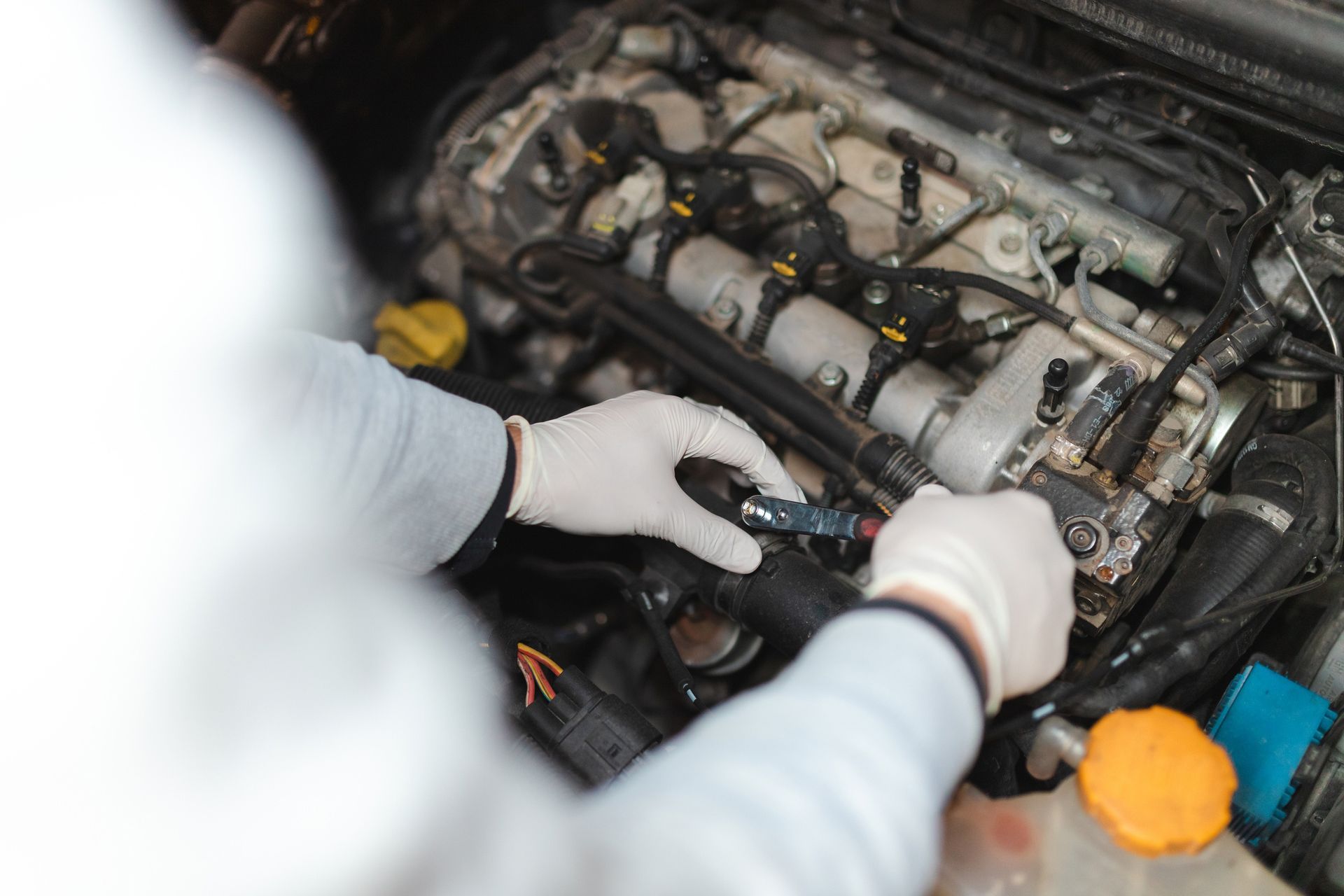Mechanic's Hands Working on a Car Engine — Des Plaines, IL — Schimka Auto Wreckers Inc