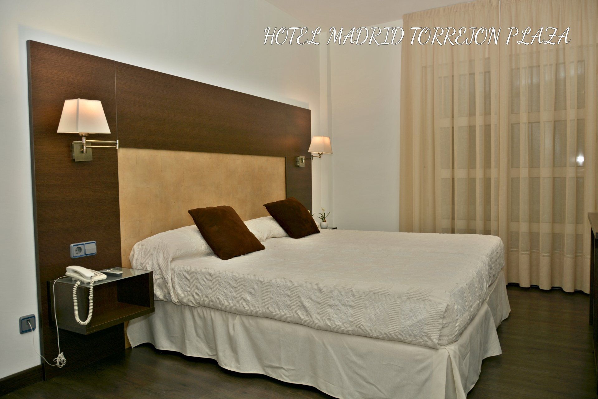 Una habitación de hotel con una cama grande y dos lámparas.