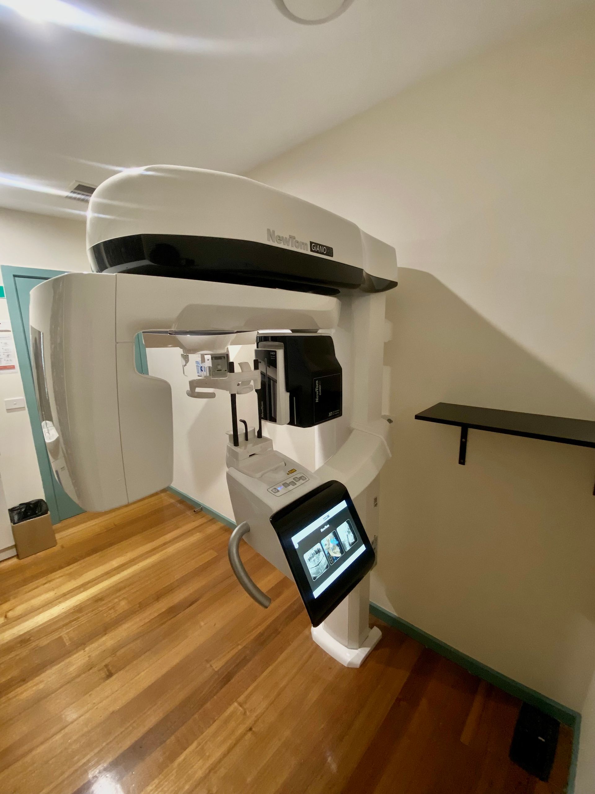 Two female dentists are working on a computer in a dental office.