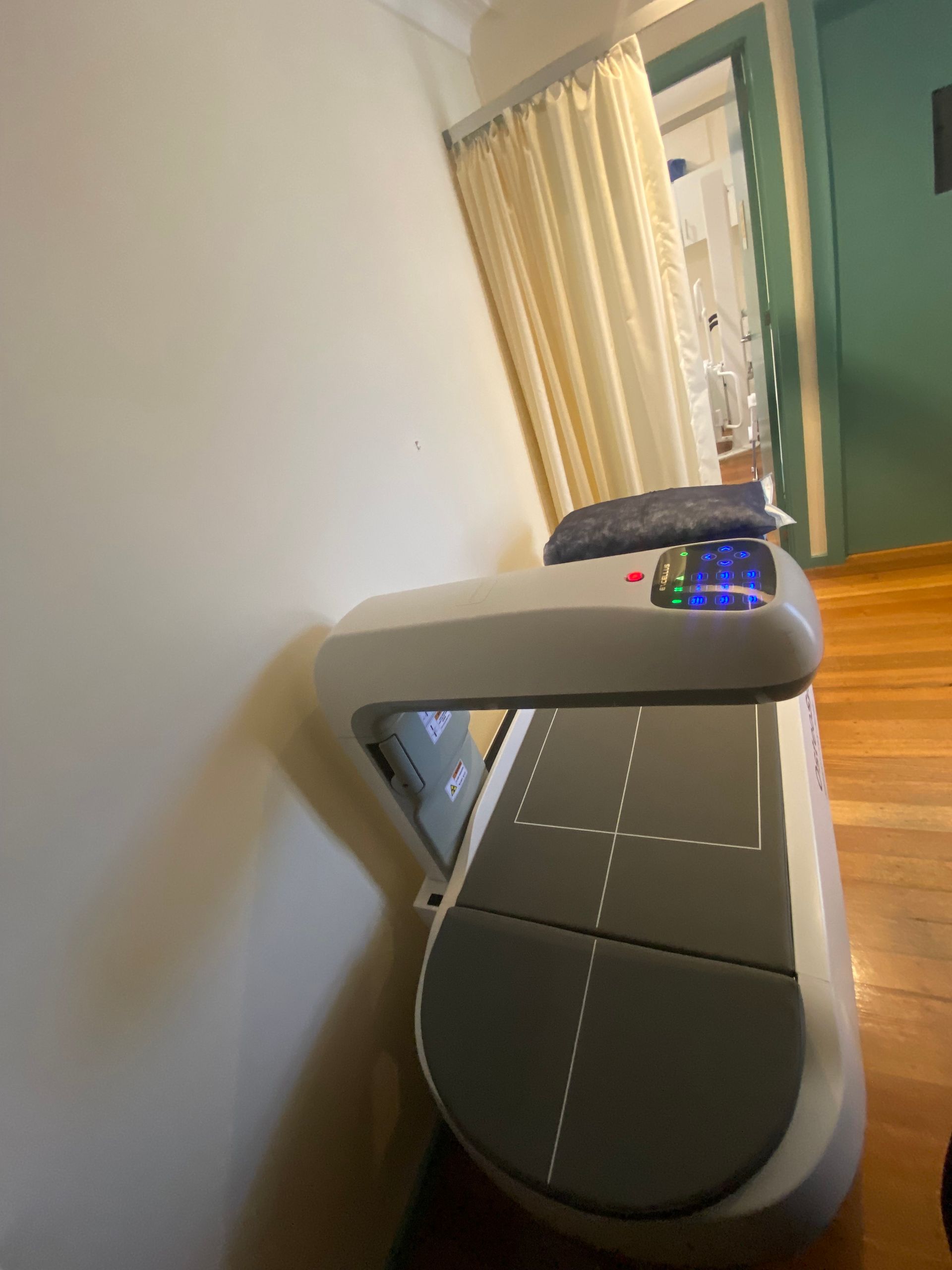 A man is looking at an x-ray of a person 's spine on a computer screen.