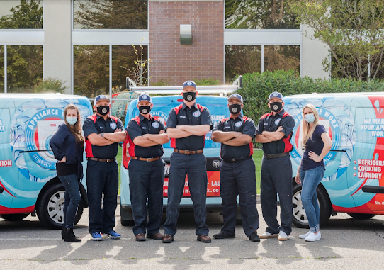 A kitchen with white cabinets and a large island in the middle.