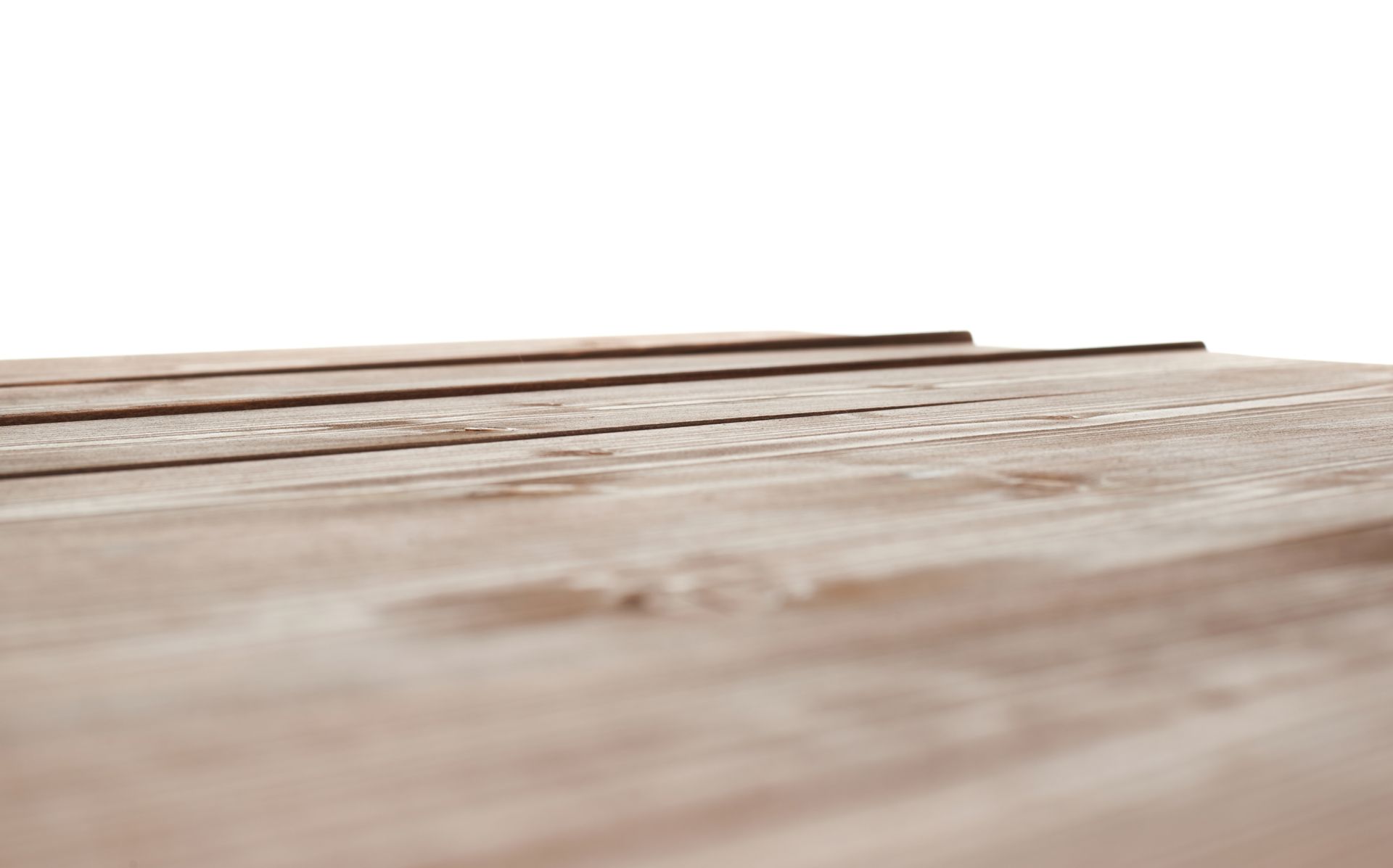 Close-up of weathered wooden planks, focus on texture and grain, with two dark lines on top.