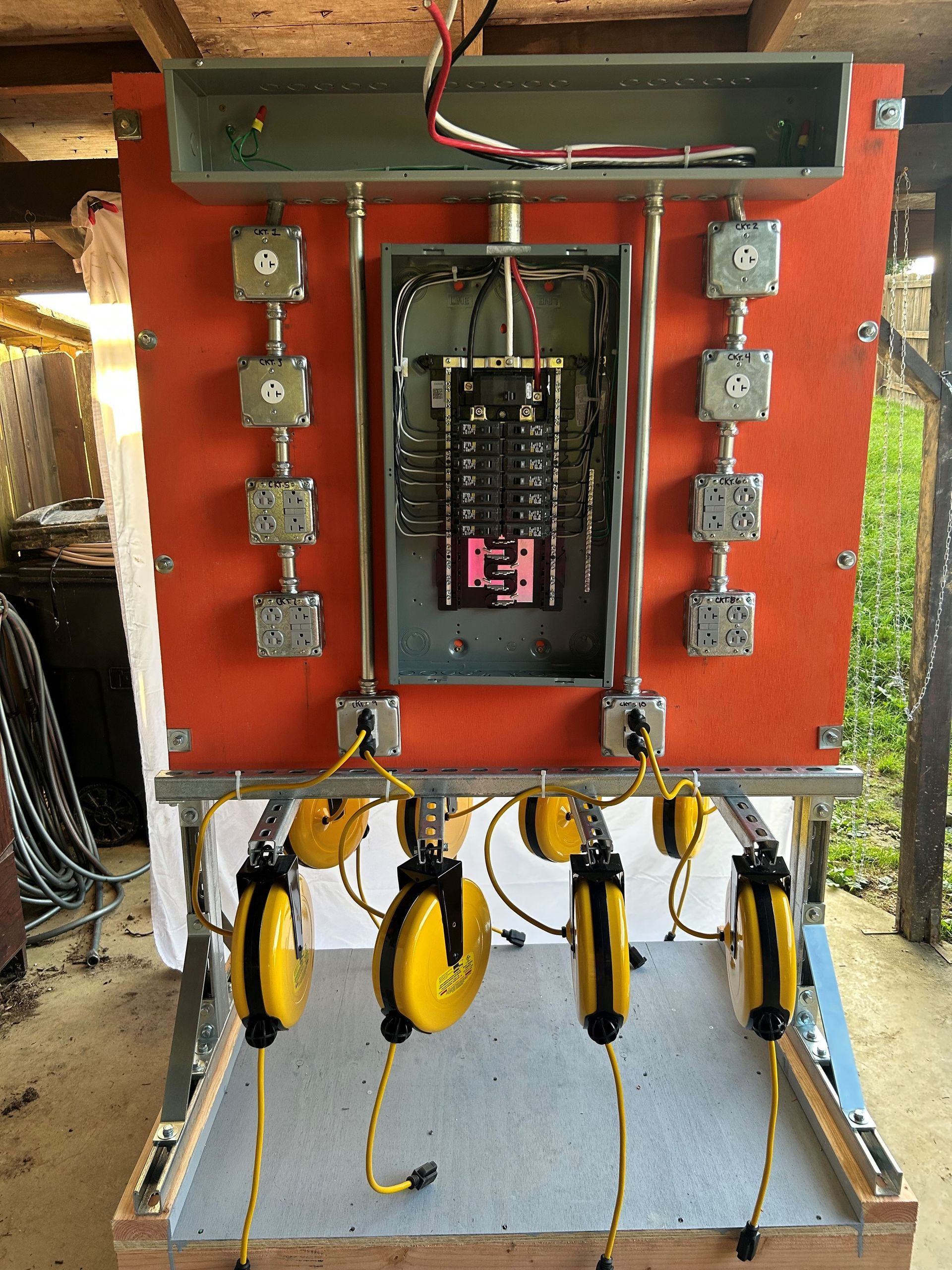 A pile of wood is sitting next to a dumpster at a construction site.