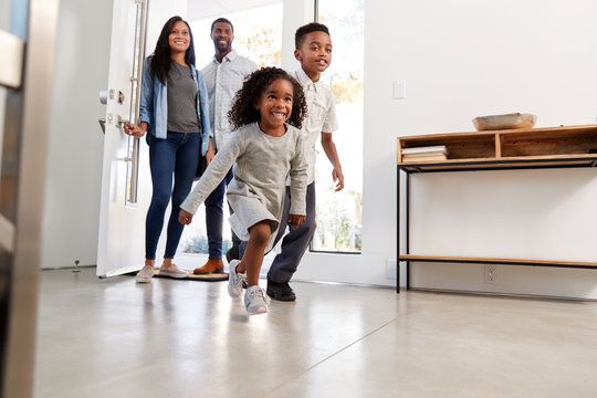 family smiles in their home