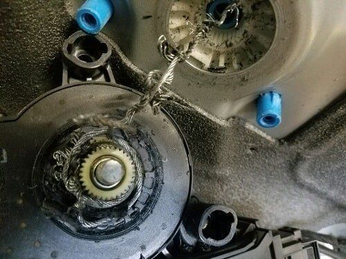 A close up of a piece of metal with a gear on it