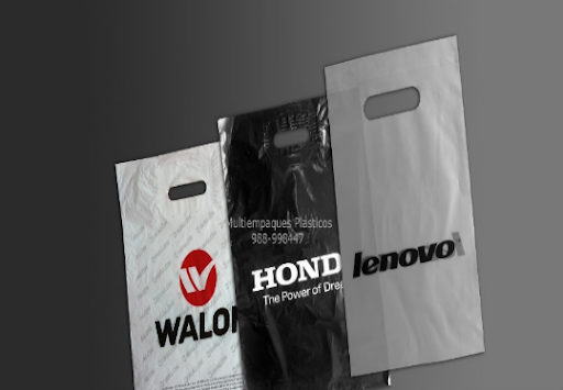 Tres bolsas de plástico con logotipos están una al lado de la otra sobre una mesa.