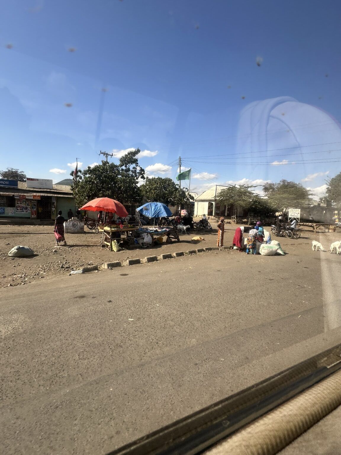 A group of people are standing on the side of the road.