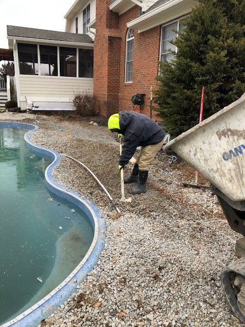 Man Working on Pool Deck — Noblesville, IN — Concrafters Inc.