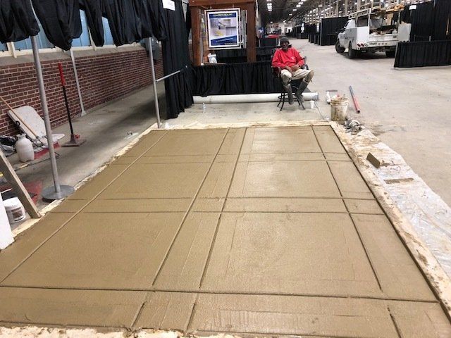 Person Looking at the Wet Concrete Floor — Noblesville, IN — Concrafters Inc.