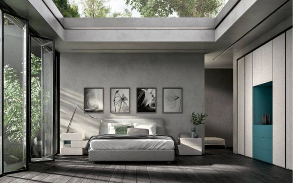 camera con arredi grigi e dettaglio verde acqua