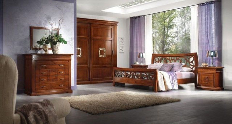 camera da letto con letto, armadio e comò in legno