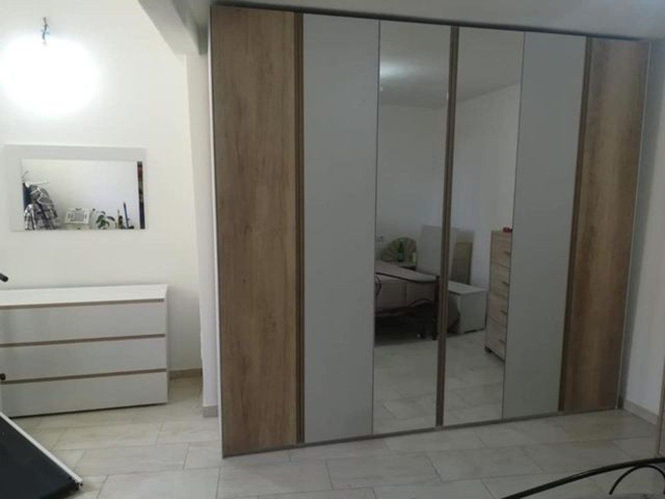armadio con inserti in specchio, elementi bianchi e in legno