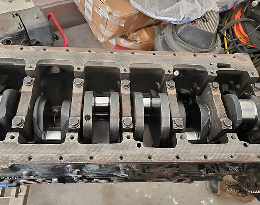 Engine block with crankshaft and connecting rods visible.