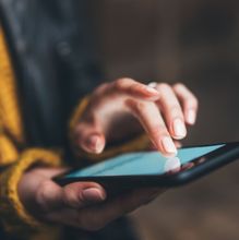 Photo of a person's hands using a phone