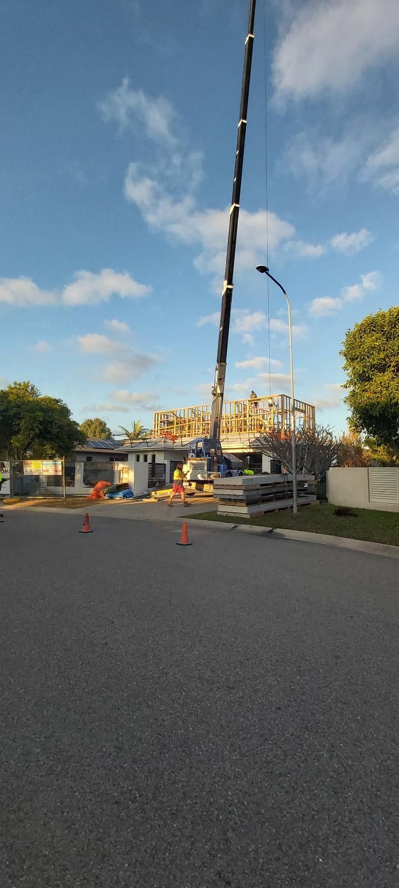 A Large Crane is Lifting a Building in the Air — Wilkinson Homes in Annandale, QLD