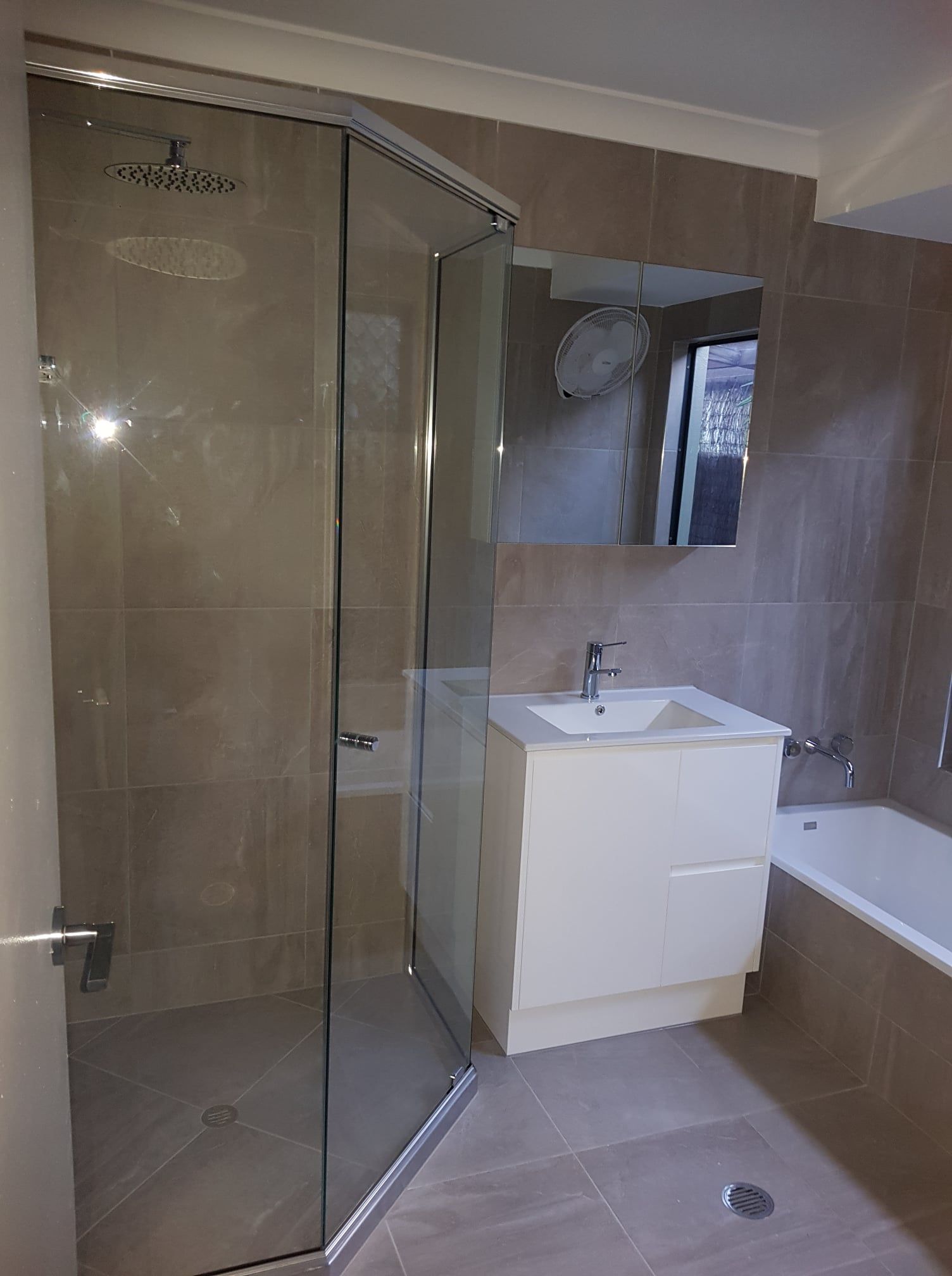 A Bathroom With a Sink, Shower, and Bathtub — Wilkinson Homes in Annandale, QLD