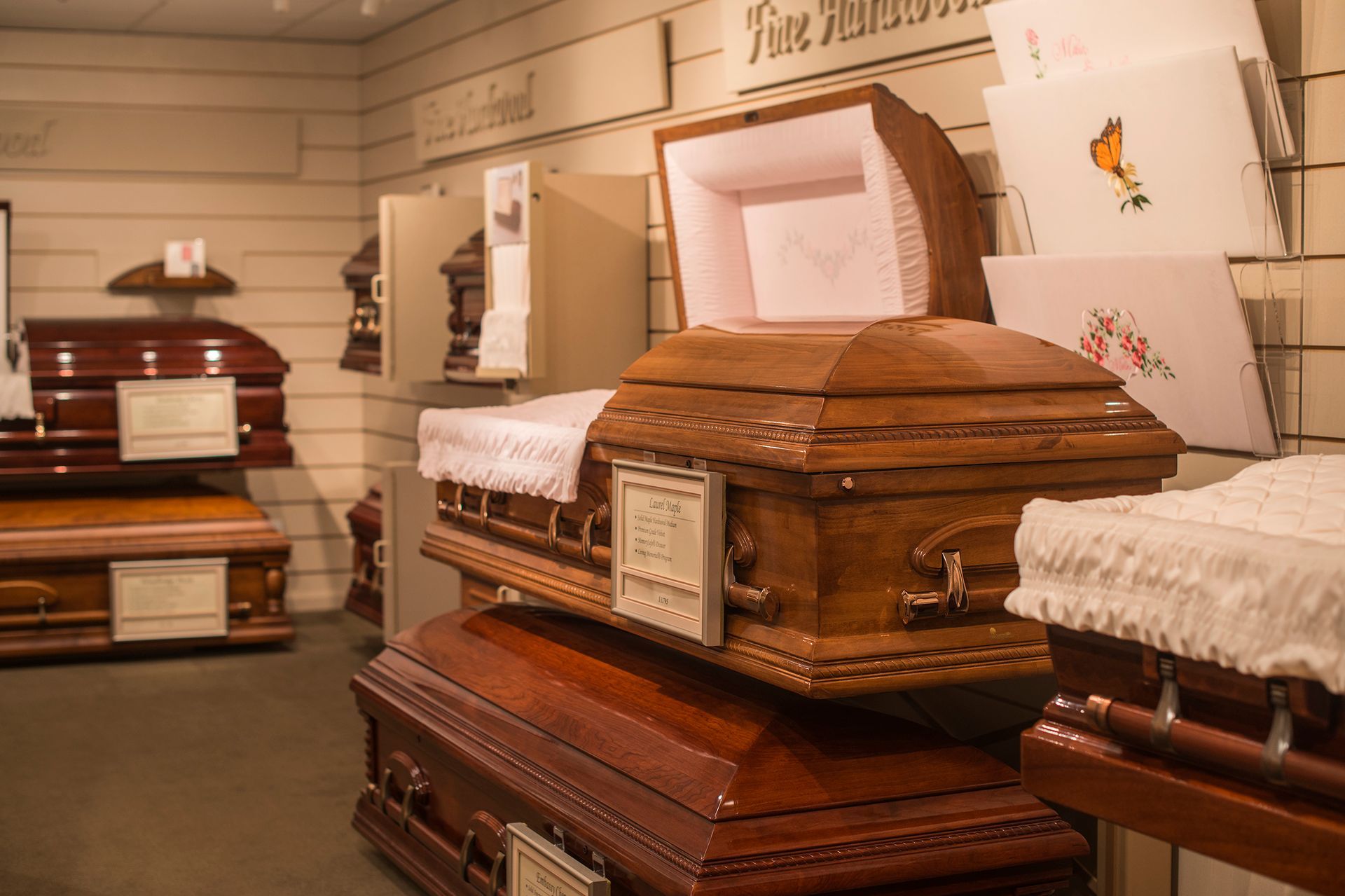 A display of wooden coffins in a funeral home.