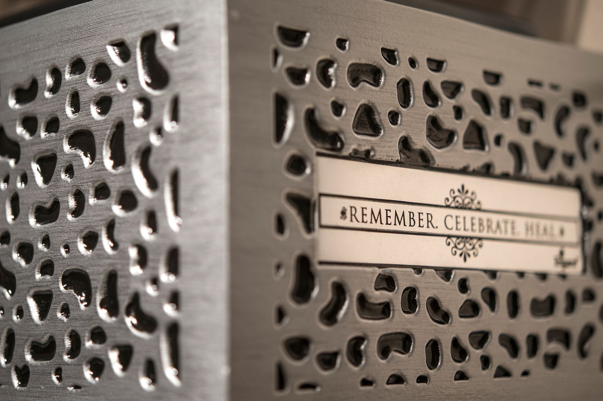 A metal box with a sign that says remember celebrate heal
