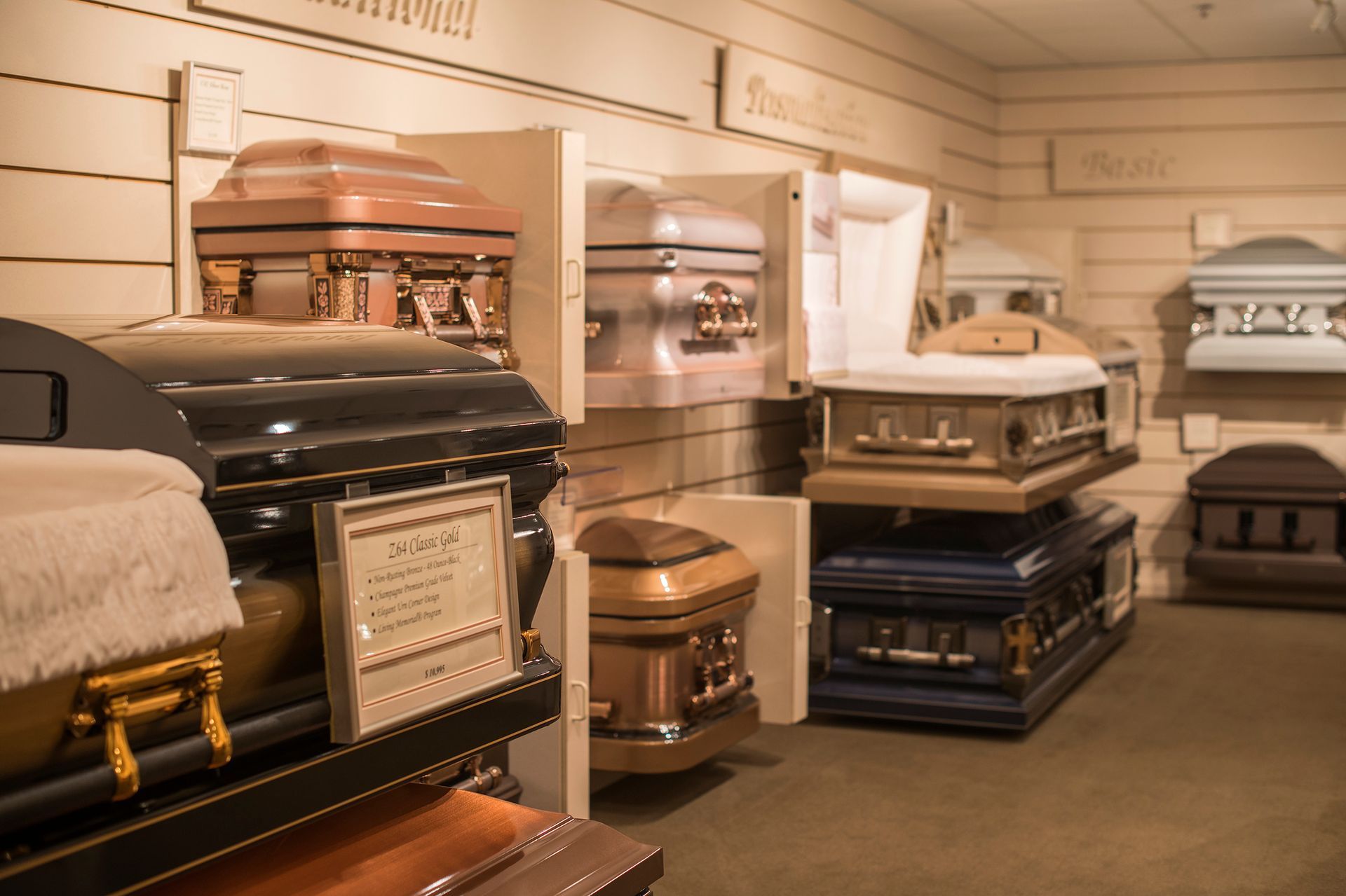 There are many different types of coffins on display in this room.