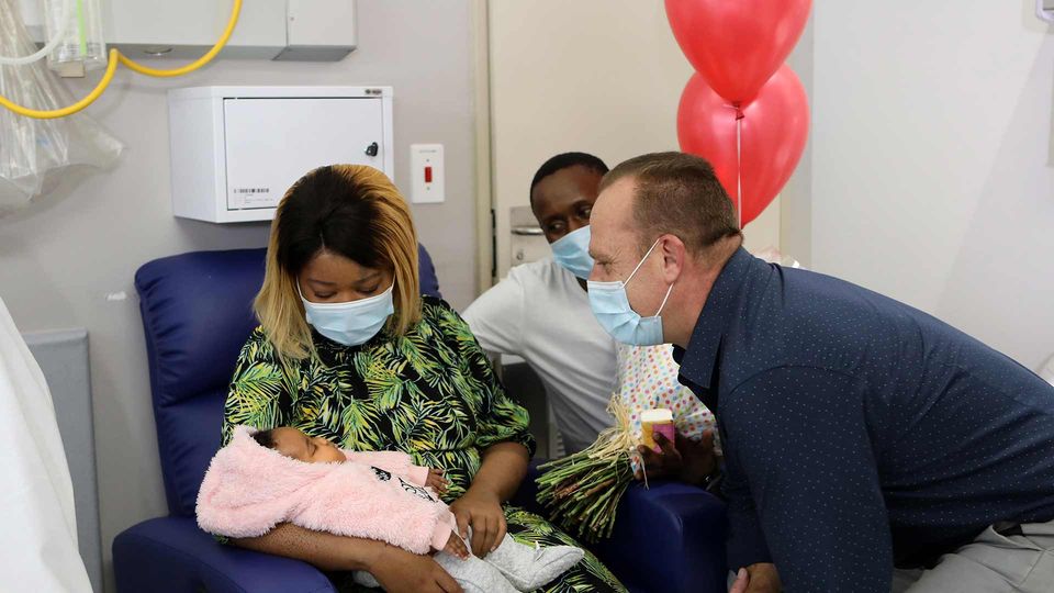 Mbali Mbatha and her husband Sizwe show off their baby daughter, Kuhle to Marc van Heerden, general manager of Netcare Milpark Hospital.