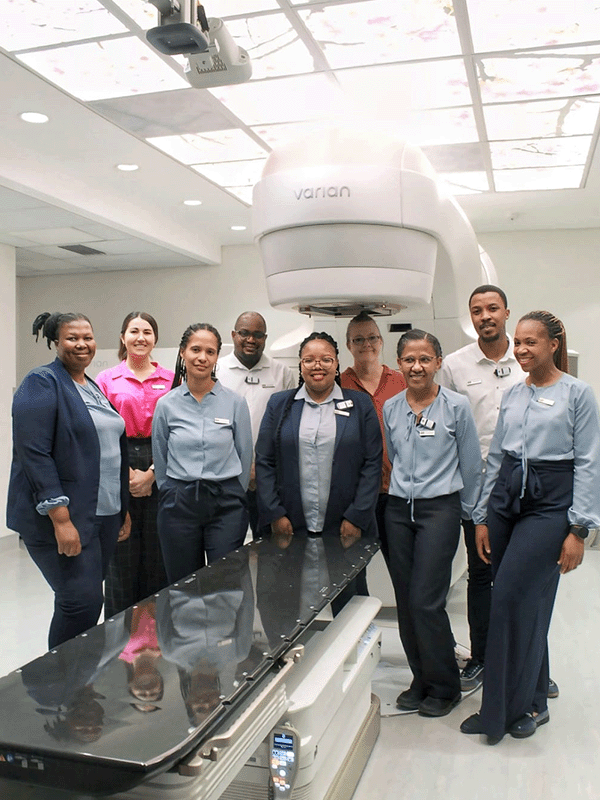 Netcare Alberton Hospital radiation therapy unit manager Busi Mzelem and the caring, experienced radiation therapy team are pictured with the Varian TrueBeam™. More than 300 people have been treated with the precision system since it was installed in February 2024.