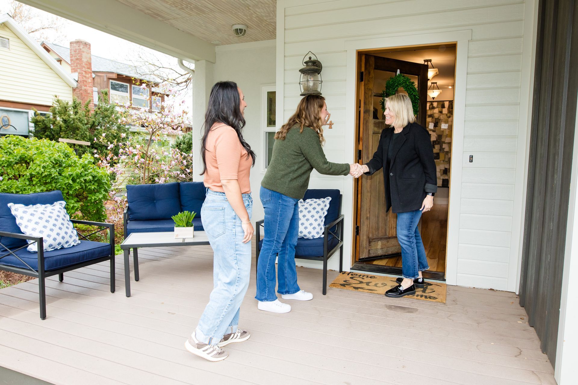 property manager for festival rentals greets short-term guests at the door
