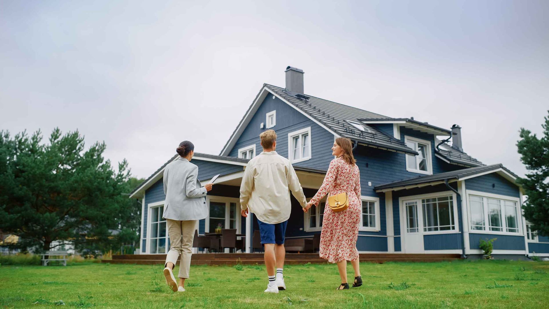 Property manager walking with a young couple to see their home.