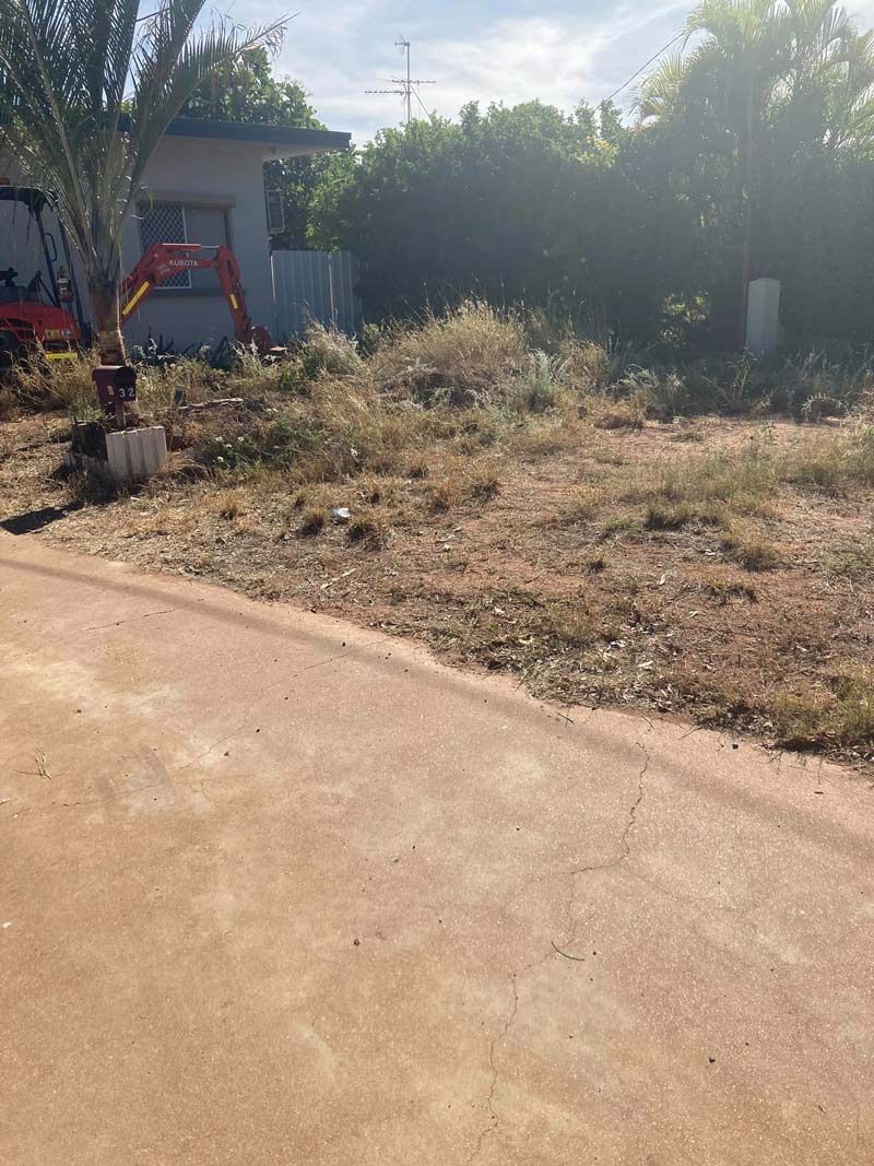 Yard With A Fence And A House In The Background With Excavator Before — NQES Industries in Burketown, QLD
