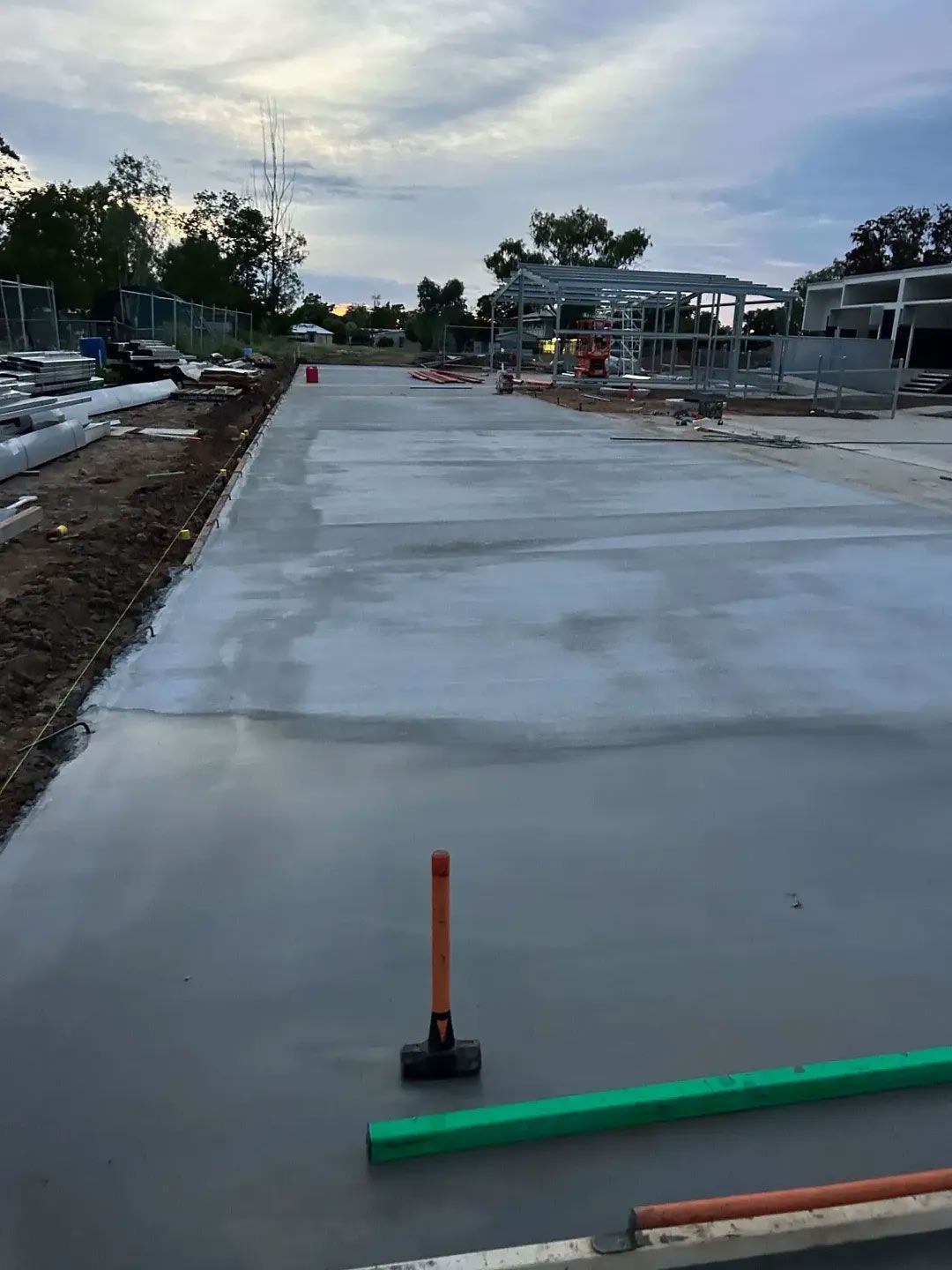 A Concrete Driveway And Road Is Being Built On A Construction Site — NQES Industries in Ryan, QLD