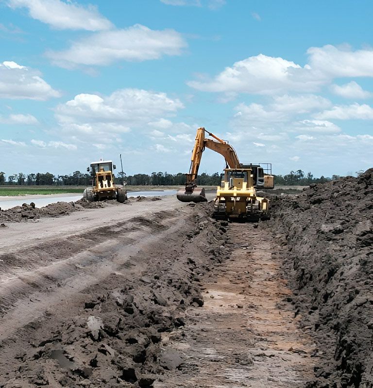 A couple of construction equipment  Working In The Large Construction Site — NQES Industries in Ryan, QLD