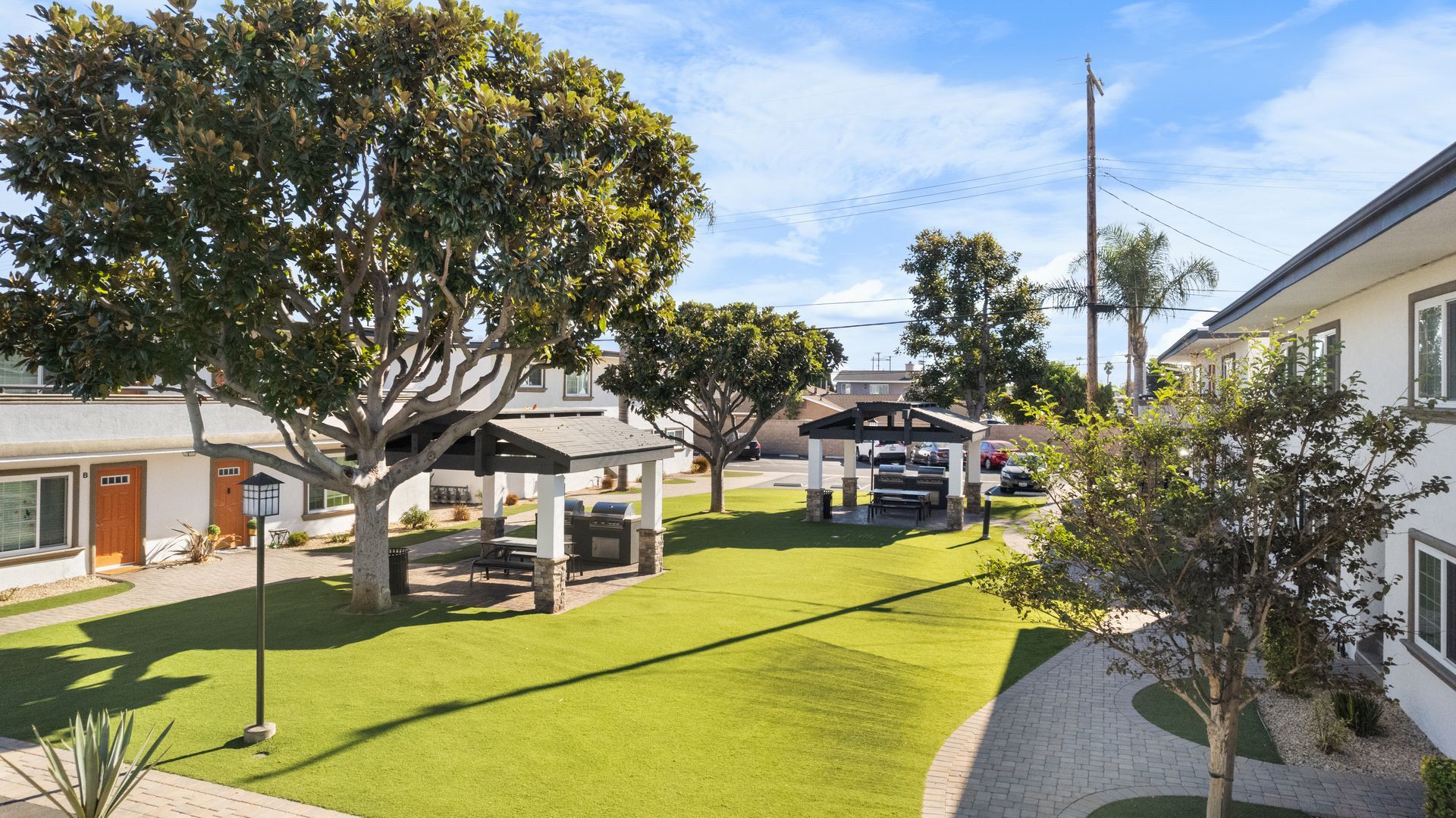 Turf field with two gazebos and BBQ grills